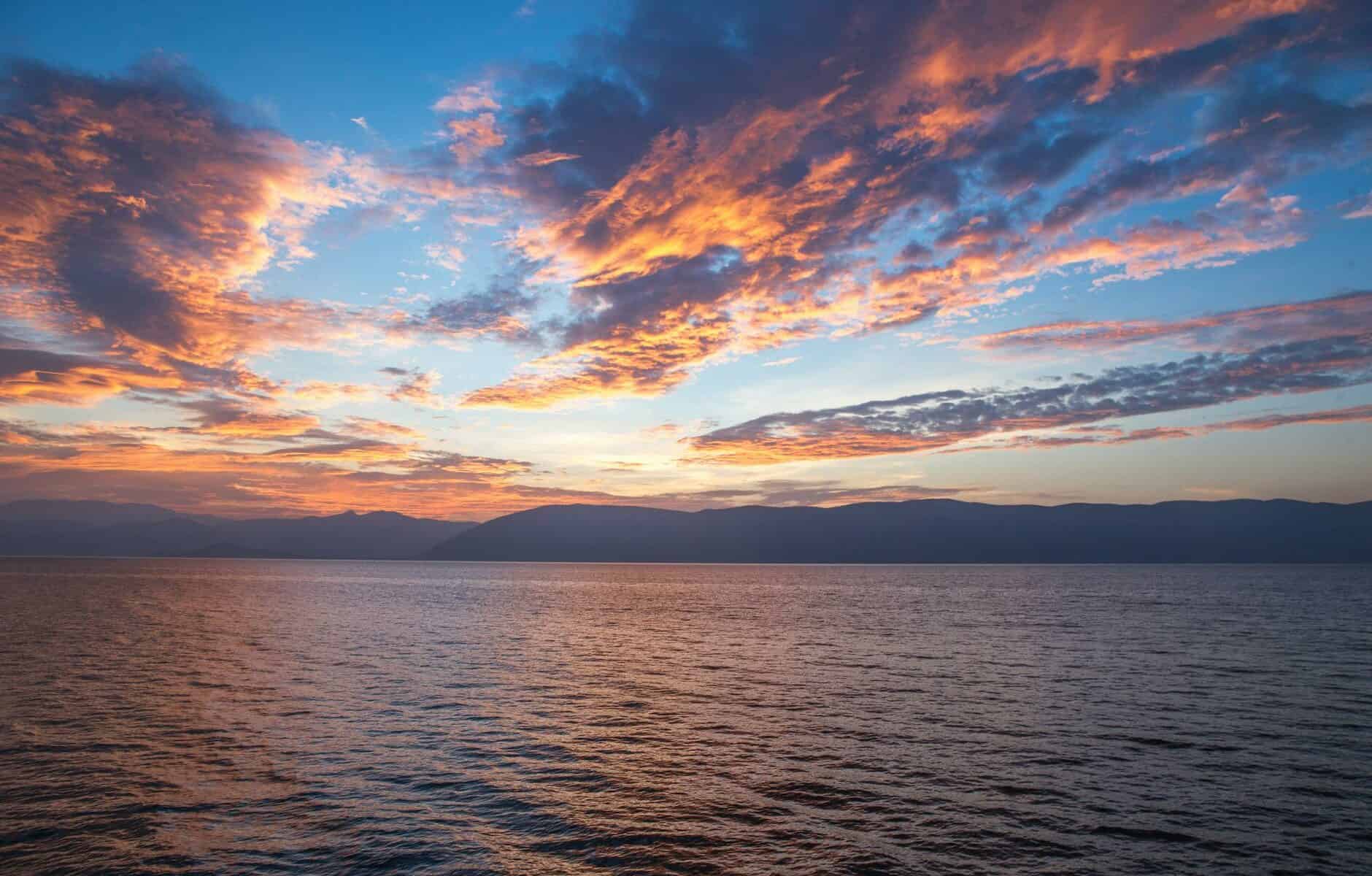 body of water under cloudy sky during daytime