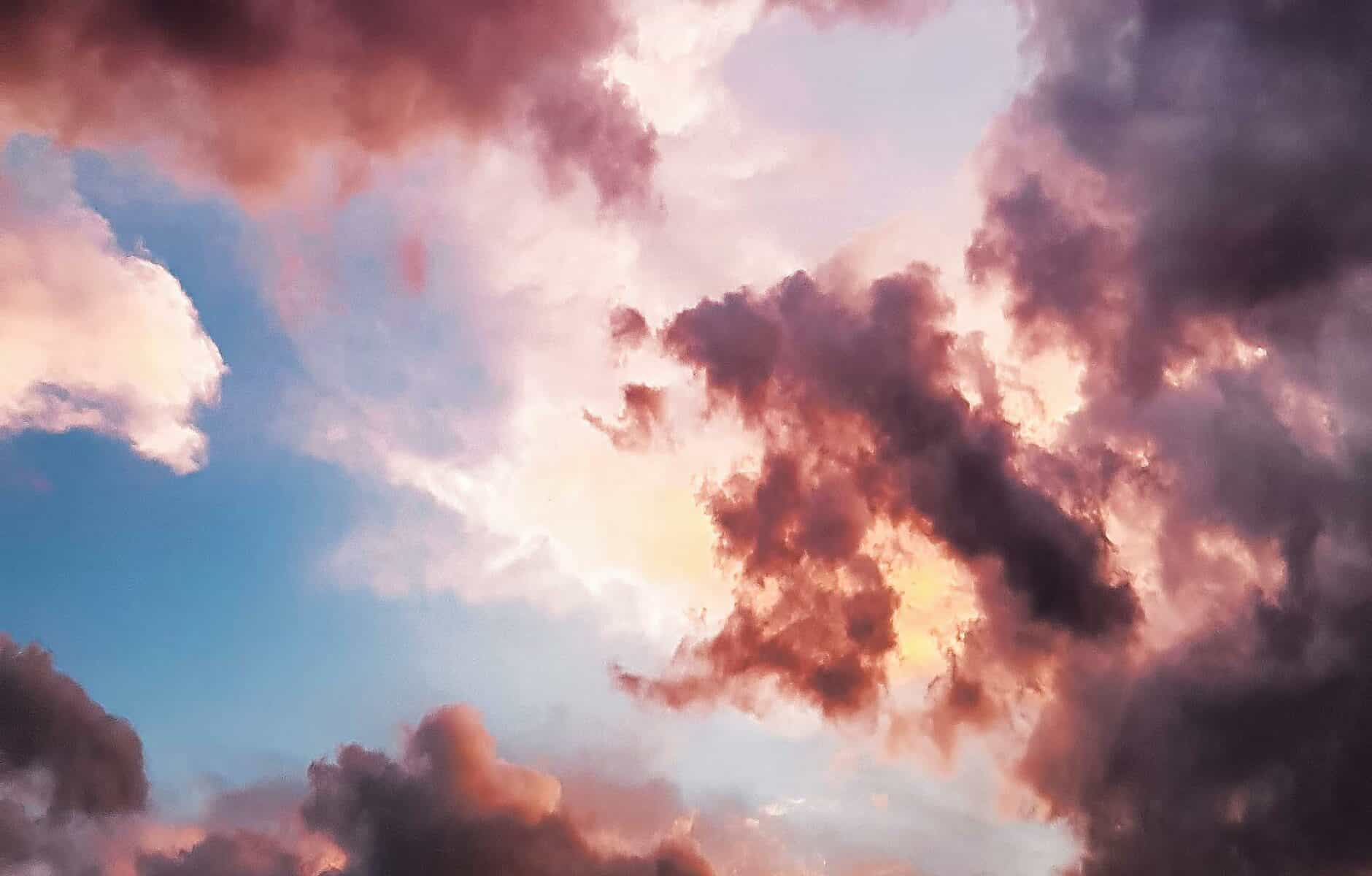 a pink and blue sky with clouds